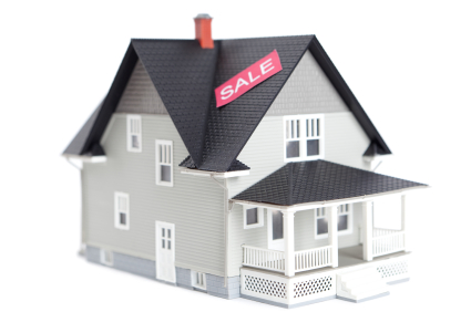 Home architectural model with sale sign, isolated